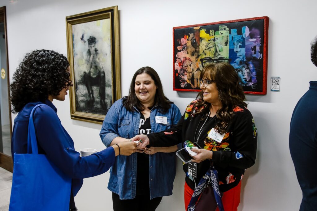 women exchanging business cards in the hallway at Sesh Coworking
